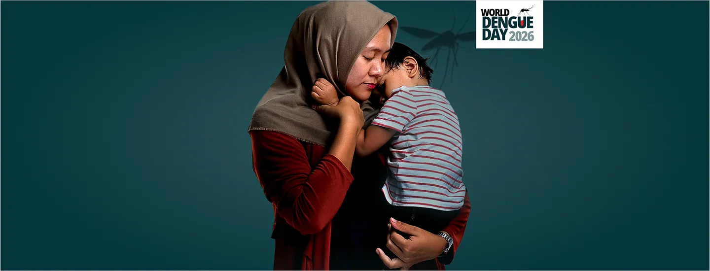 Parent holding their child close against their chest, conveying the impact dengue can have on children and families.