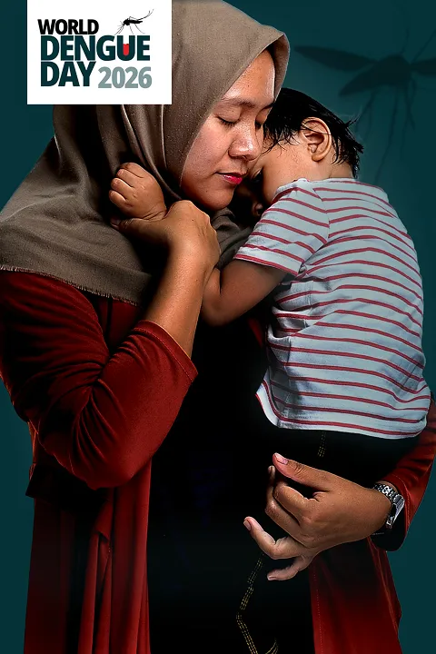 Parent holding their child close against their chest, conveying the impact dengue can have on children and families.